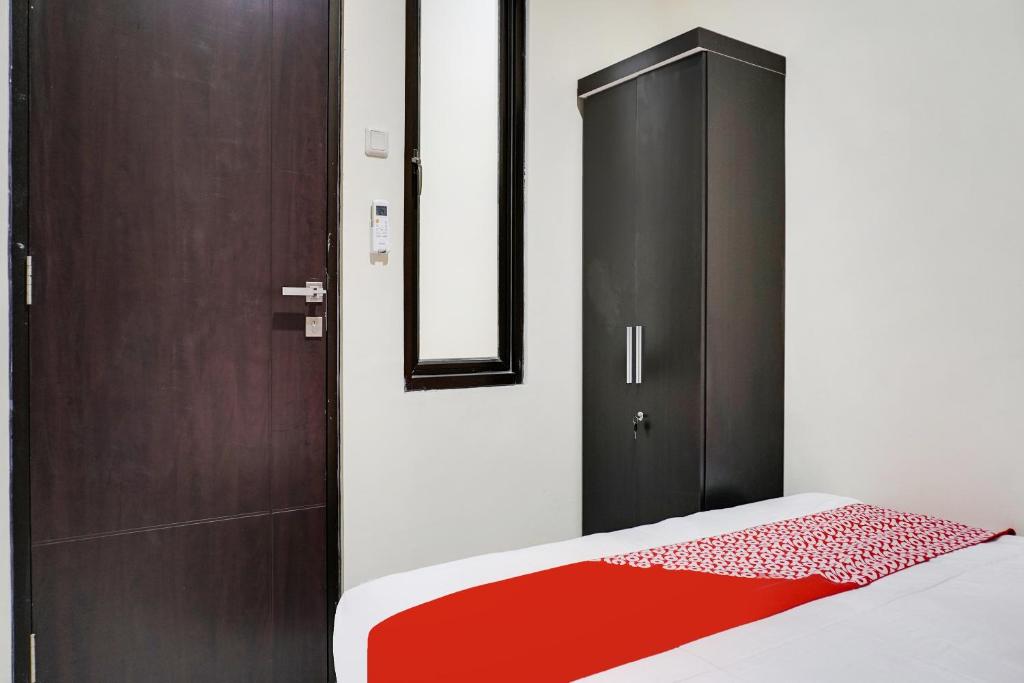 Postel nebo postele na pokoji v ubytování OYO 91646 fio colombus residence