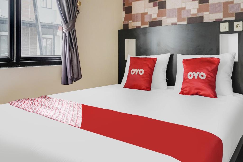 Postel nebo postele na pokoji v ubytování OYO 91646 fio colombus residence