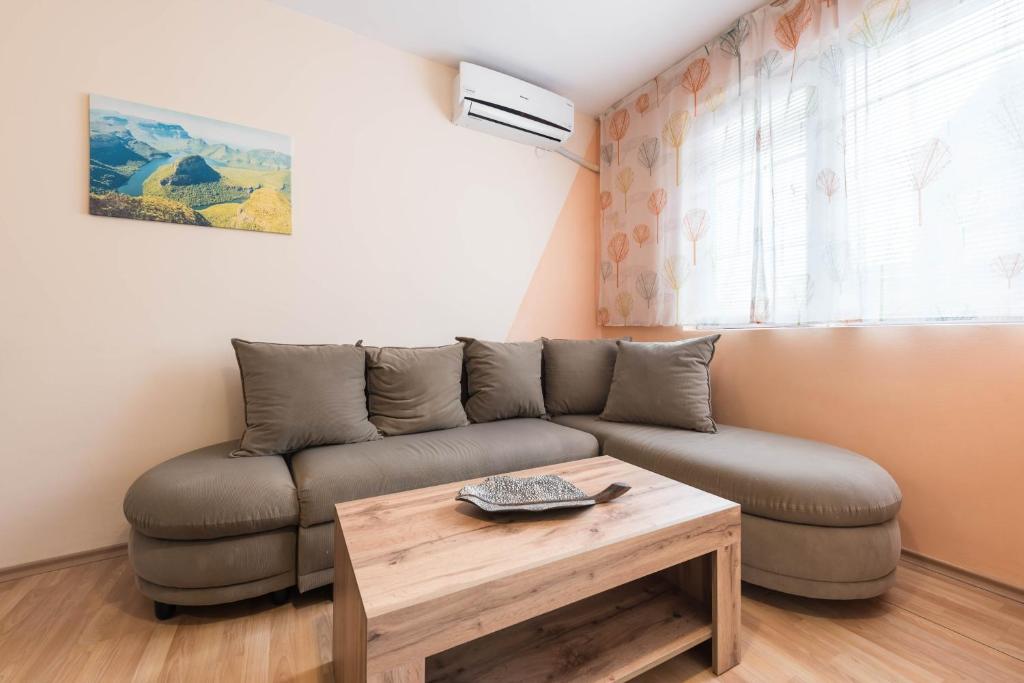 a living room with a couch and a coffee table at Sea&Park Apartment by Linas BNB in Varna City