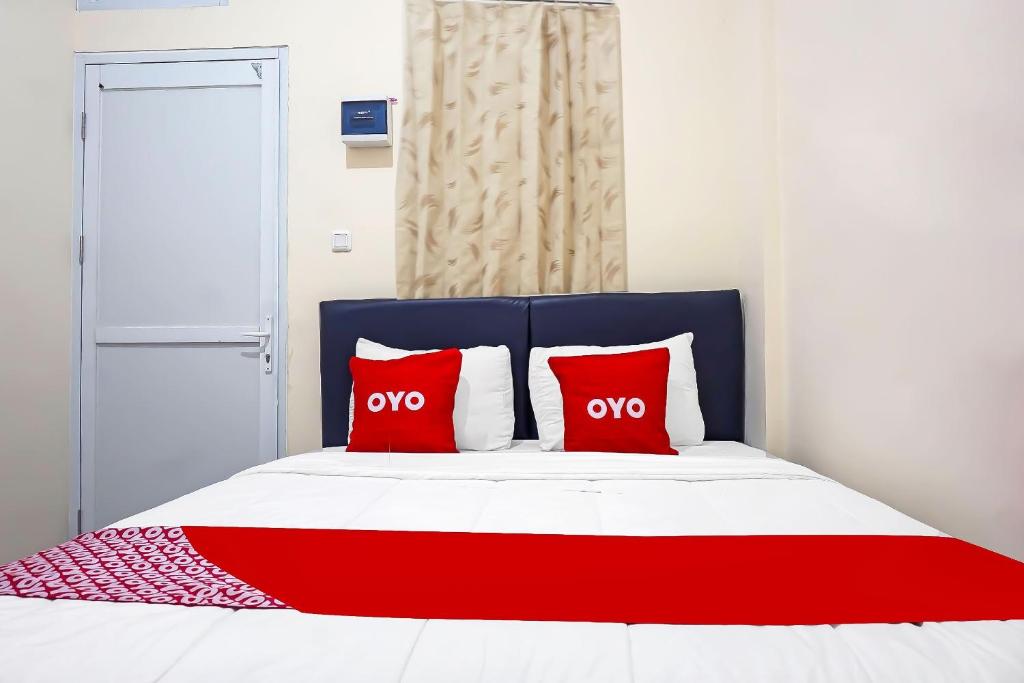 Postel nebo postele na pokoji v ubytování Super OYO Capital O 91790 S1 Residence