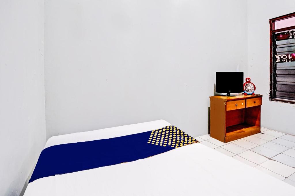 Postel nebo postele na pokoji v ubytování OYO 91891 B41m Residence Syariah
