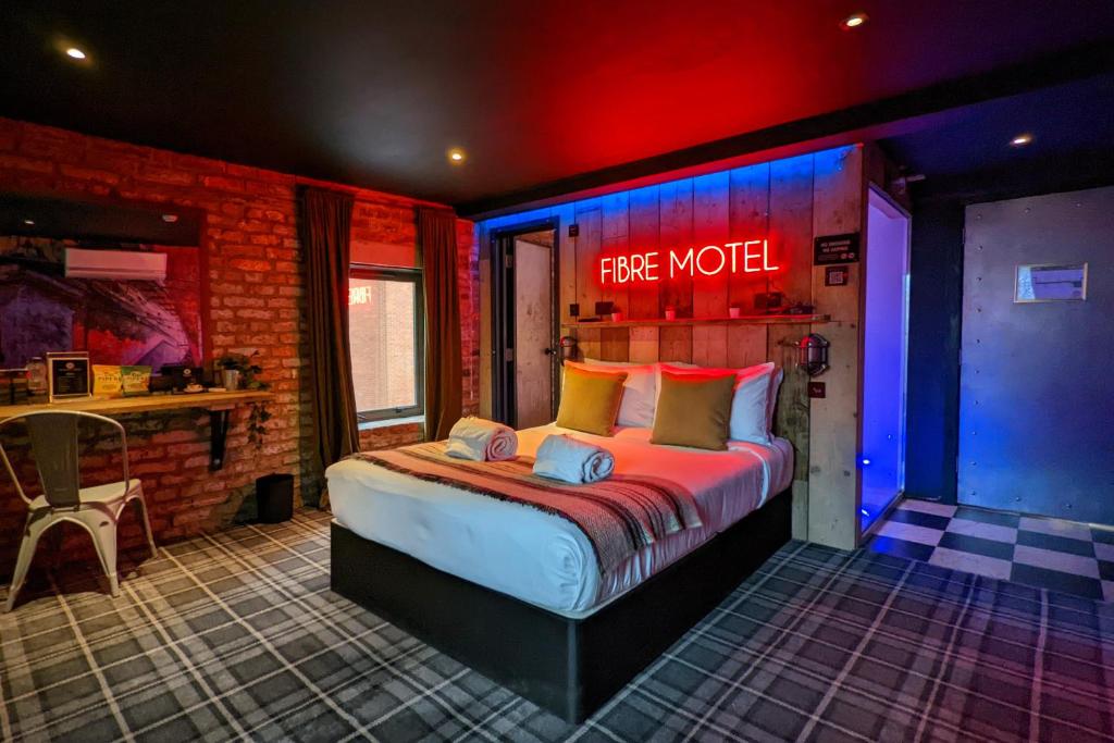 a bedroom with a large bed in a brick room at Briggate Hotel in Leeds