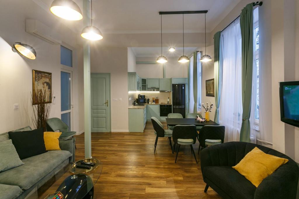 a living room with a couch and a table at Klimt's Puzzle Suite in Sofia