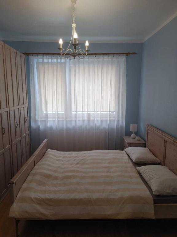 Posteľ alebo postele v izbe v ubytovaní Apartament Julia