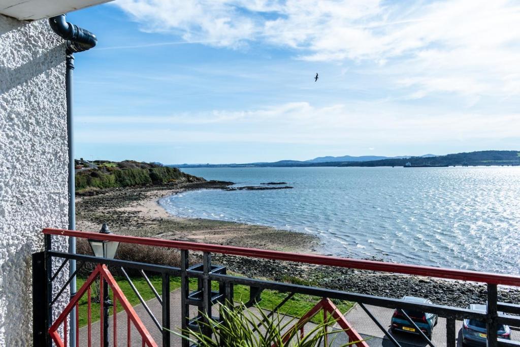 a view of the water from a balcony at Penthouse River View near Edinburgh in Saint Davids