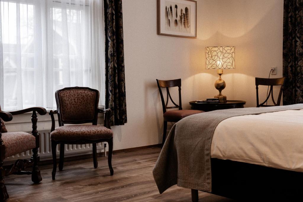 Postel nebo postele na pokoji v ubytování Landhotel De Hoofdige Boer