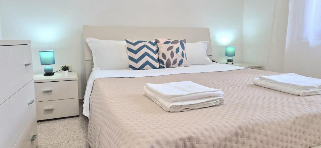a bedroom with a bed with two towels on it at Luce in Santa Maria Navarrese