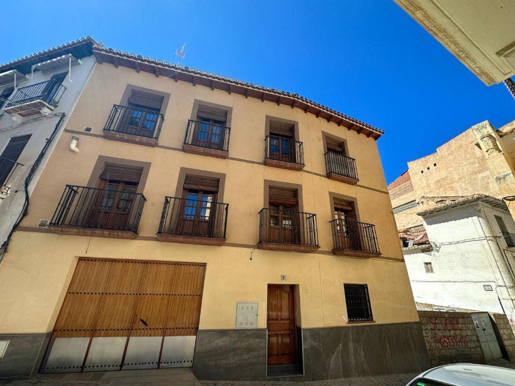 a building with balconies on the side of it at La casa de Felipe y Paquita in Guadix