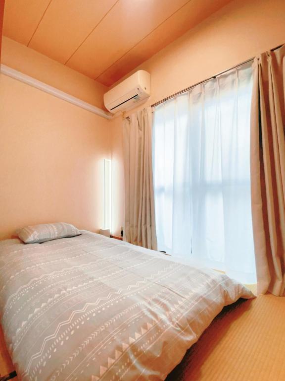Postel nebo postele na pokoji v ubytování home story in Tokyo Okubo 東京屋語 in 新大久保 新宿