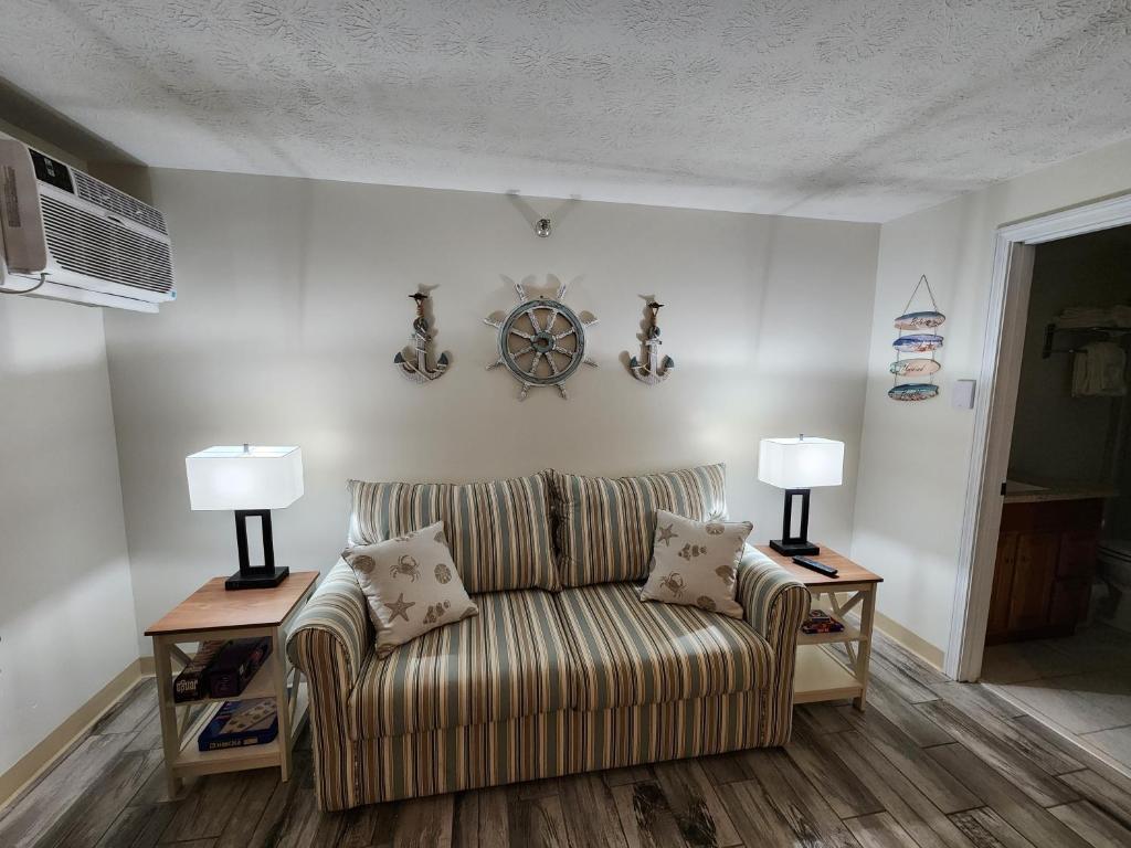 a living room with a couch and two lamps at Nautical Mile Resort in Wells