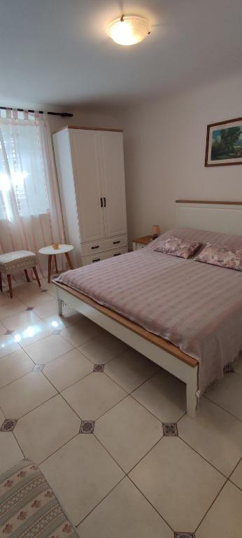 a bedroom with a large bed in a room at Guesthouse Palma in Mali Lošinj