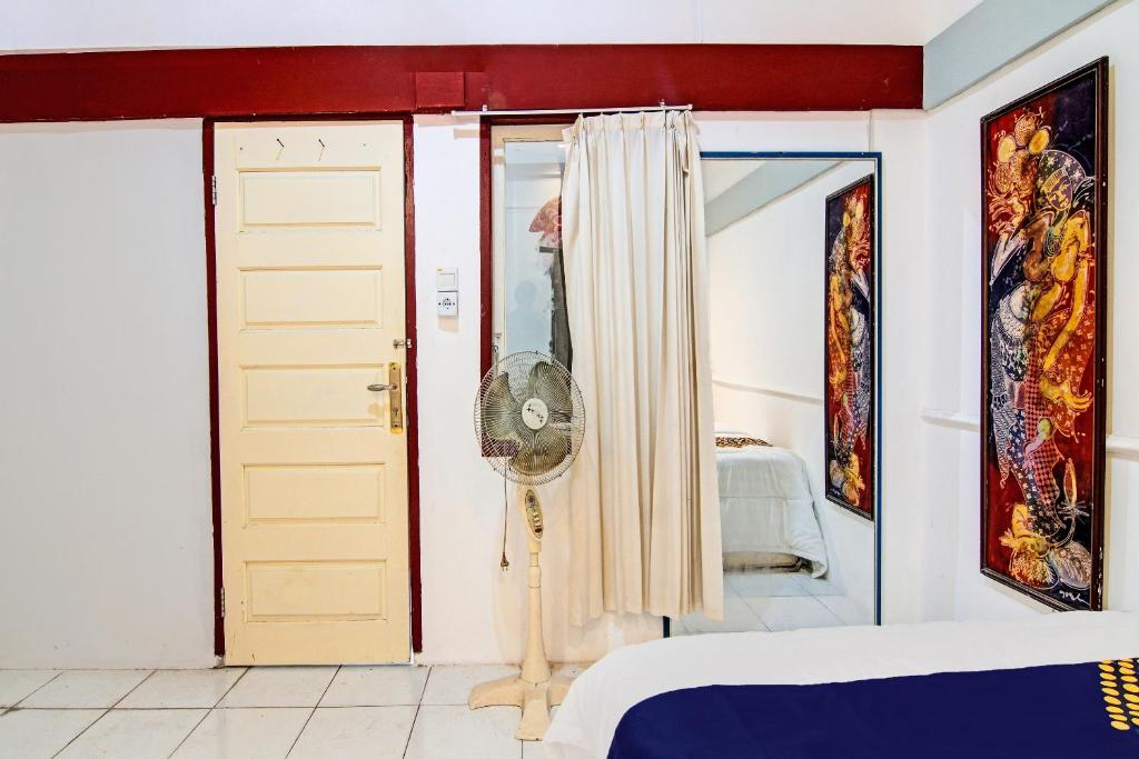 Ένα ή περισσότερα κρεβάτια σε δωμάτιο στο Hotel O Aulya Homestay Syariah Near Tuanku Tambusai Stadium