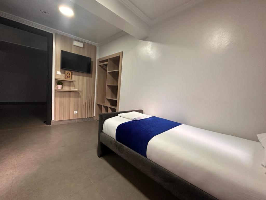 Postel nebo postele na pokoji v ubytování Hotel Cataleya Al-Hoceima