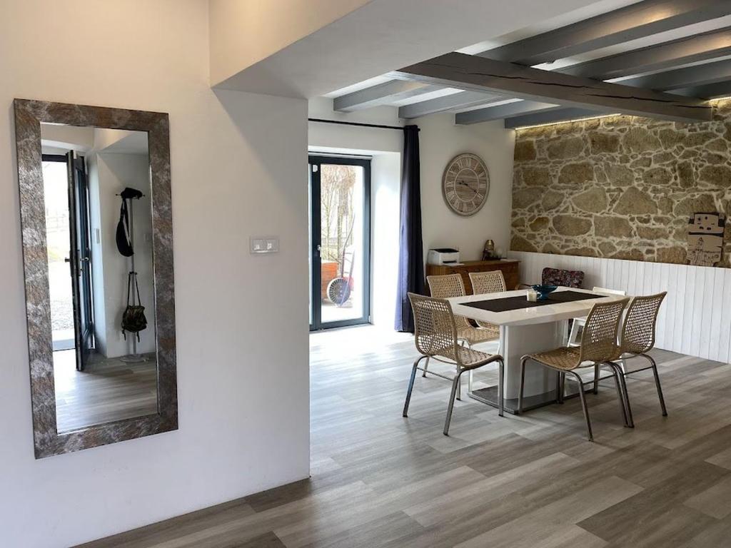 a living room with a table and chairs and a mirror at Homeland - family friendly house in Ledce