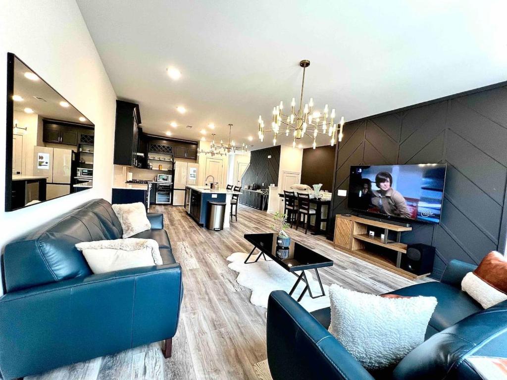 a living room with a blue couch and a tv at The Villas Antilia in Durham