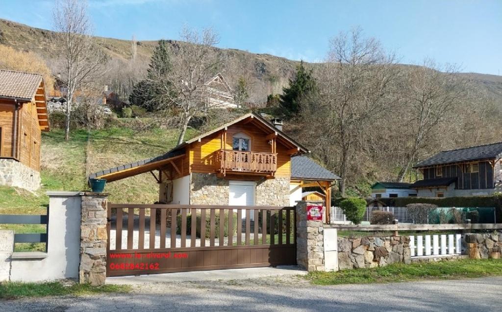 a house with a wooden gate and a fence at Les FEICHES et MARGUERITES in Ignaux