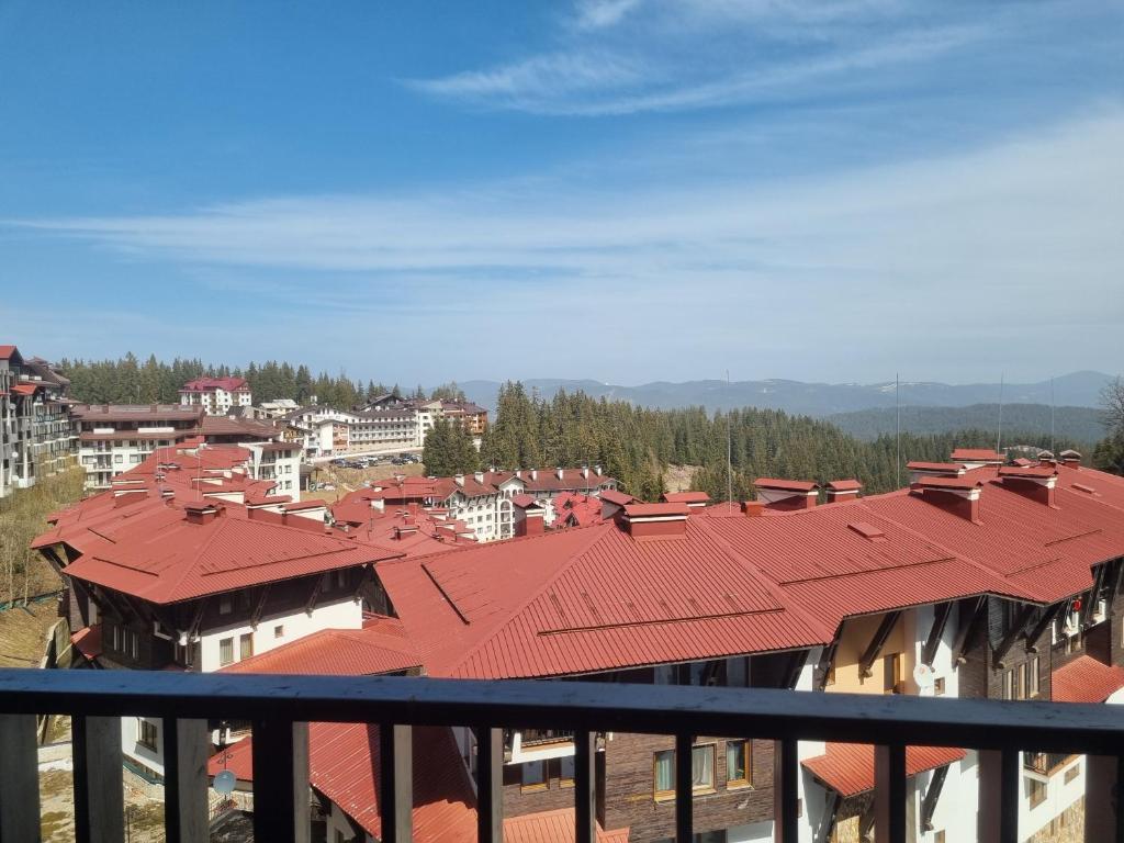 a view of a city from a balcony with red roofs at Ski & View Pamporovo Apartment in Smolyan