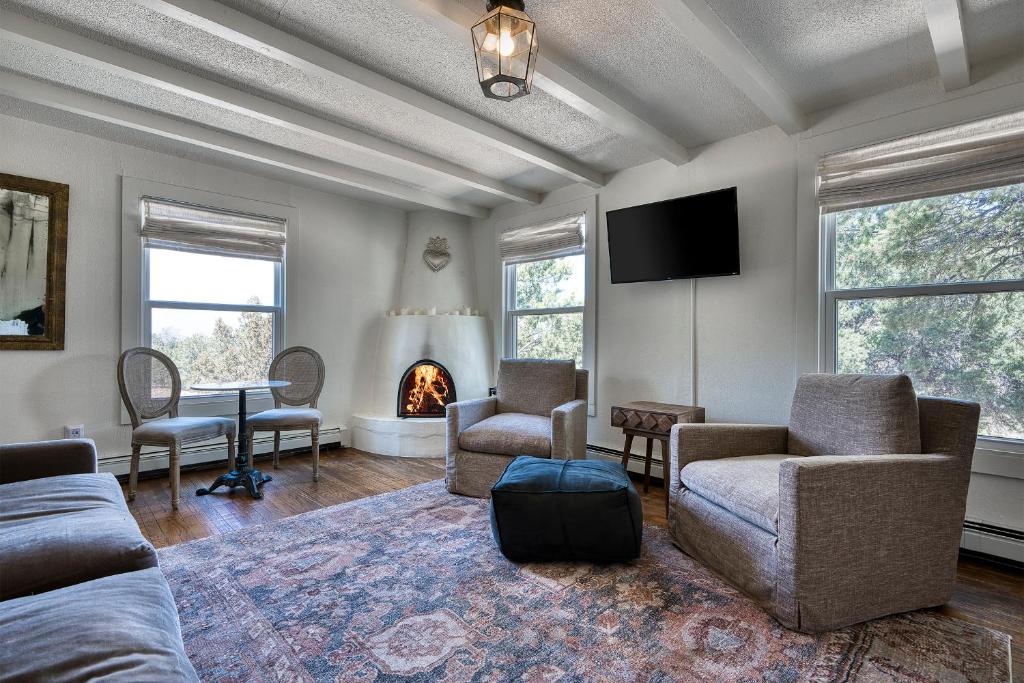 a living room with a couch and chairs and a fireplace at Tesuque Outpost Casita E Best views in Santa Fe in Santa Fe