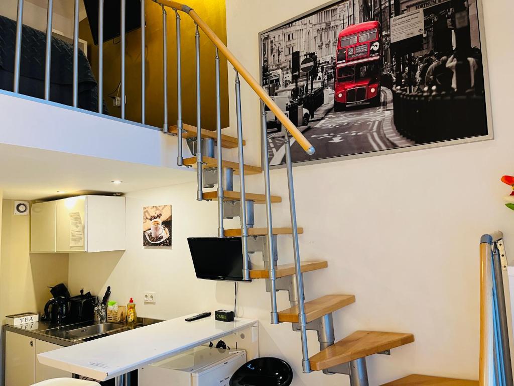 a room with a staircase and a red bus on the wall at Feldhouse in Bremen