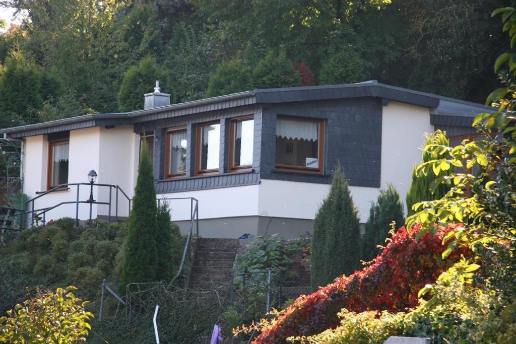 a white house with windows on a hill at Ferienhaus Burgblick in Bad Münstereifel