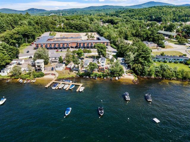 an aerial view of a resort with boats in the water at Paugus Bay Condo Close to it All in Laconia