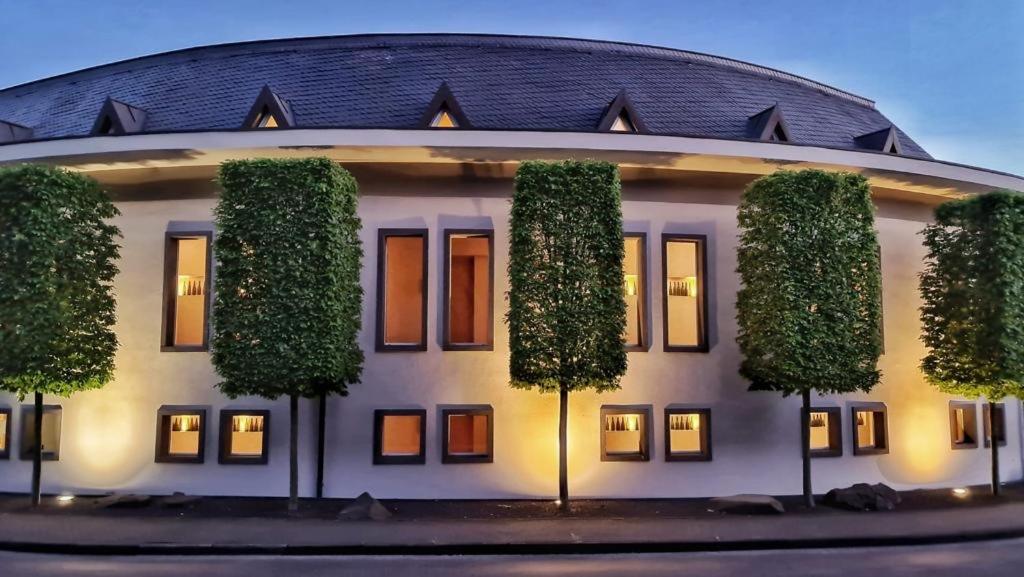 a building with trees in front of it at Weinquartier Burggarten in Bad Neuenahr-Ahrweiler