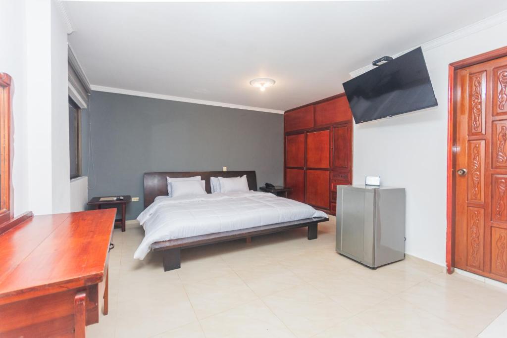 Postel nebo postele na pokoji v ubytování Hotel Baluarte Cartagena Boutique
