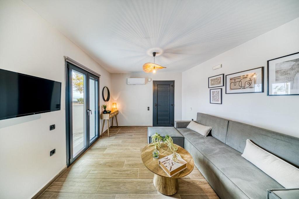 a living room with a couch and a table at Windmill Escape Apartments B in Chios