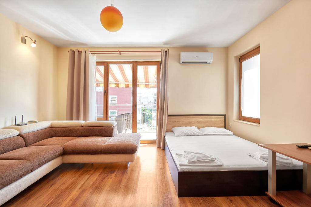 a living room with a couch and a table at Apart-Hotel Onegin & Thermal Zone in Sozopol