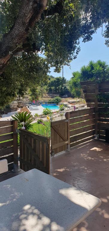 a wooden fence with a pool in the background at Casa Llogan 4P Quinta das Pedras da Lagoa in Alcobaça