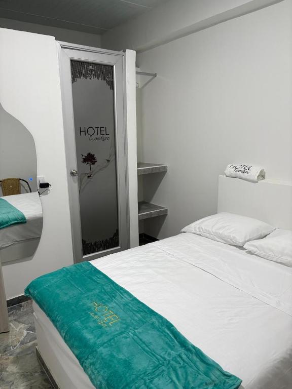 Postel nebo postele na pokoji v ubytování Hotel Guamaluno