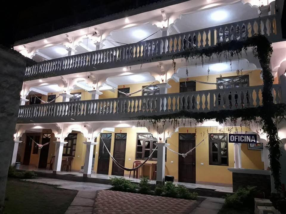 a large building with a balcony at night at Hotel TINAMIT 1 in San Pedro La Laguna