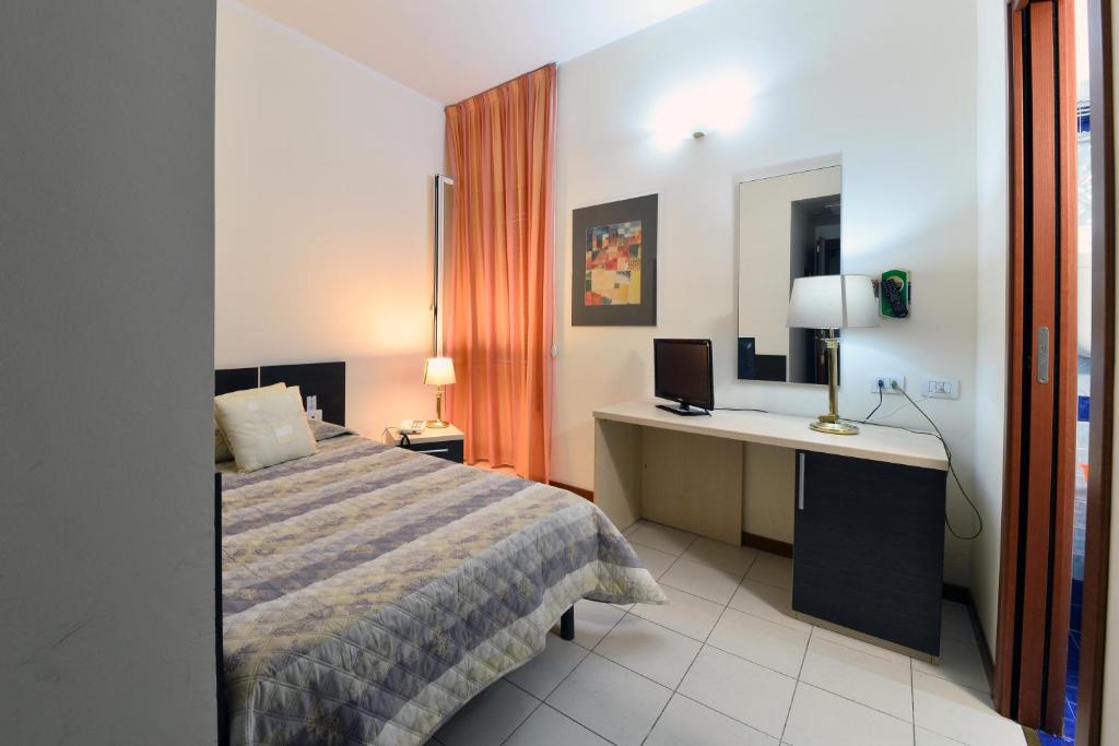 Postel nebo postele na pokoji v ubytování Hotel Ferrari