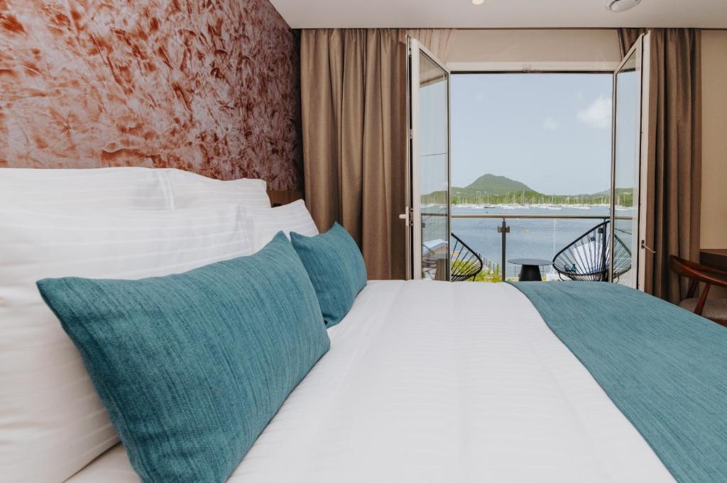 Postel nebo postele na pokoji v ubytování Sable Bleu Boutique Hotel