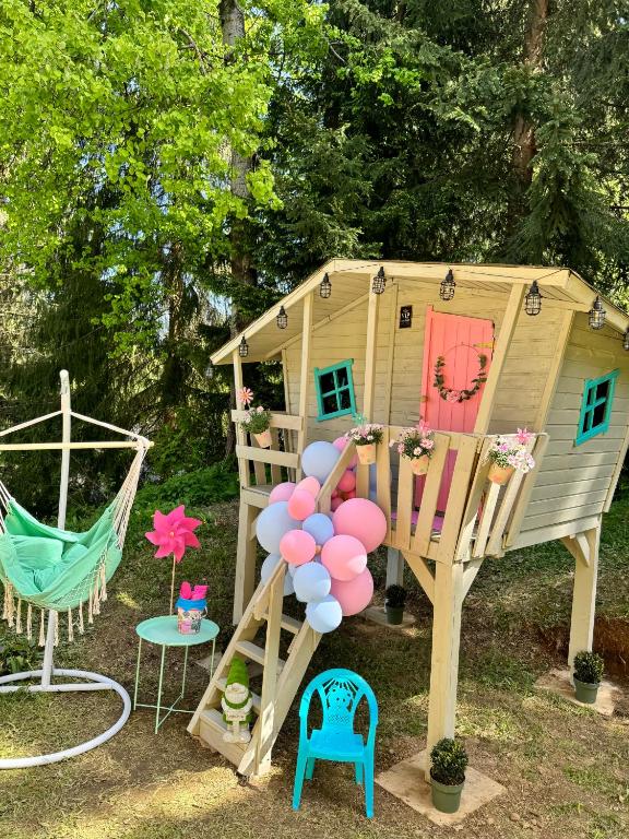 a play house with balloons and a swing at Kokava Línia chata 2 in Kokava na Rimavica
