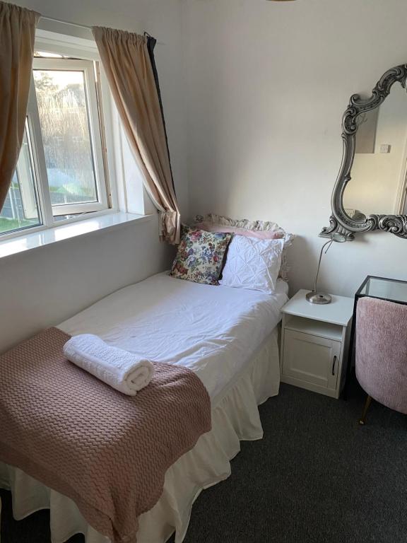 a small bedroom with a bed and a window at Upper single bedroom in Cardiff