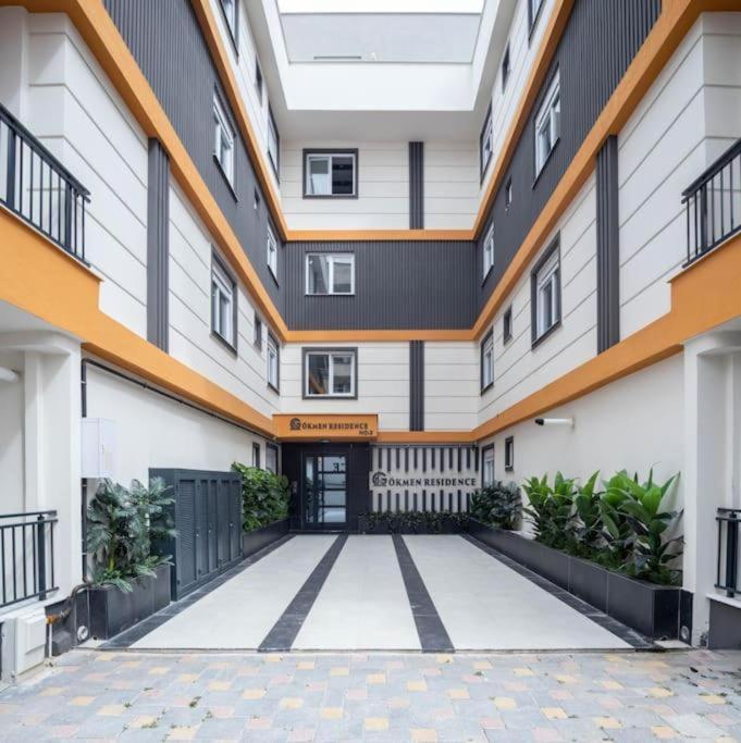 an empty courtyard of a building with a garage at Central Location 2 Bedroom Apt in Antalya