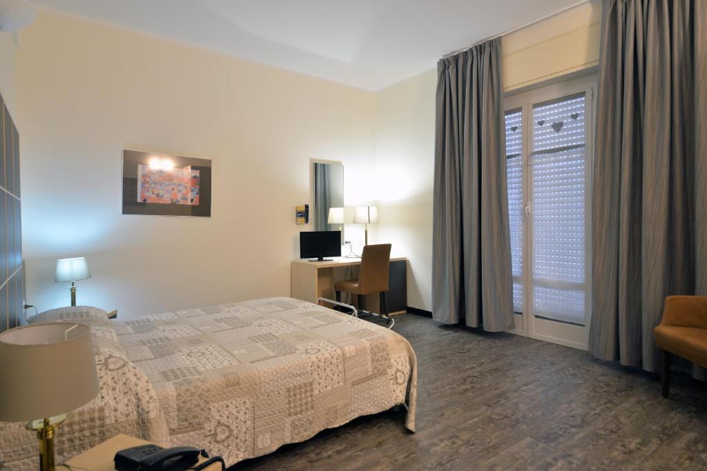 Postel nebo postele na pokoji v ubytování Hotel Ferrari