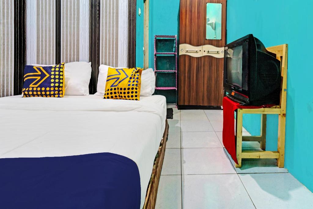 Postel nebo postele na pokoji v ubytování OYO 92269 Arjuna Homestay