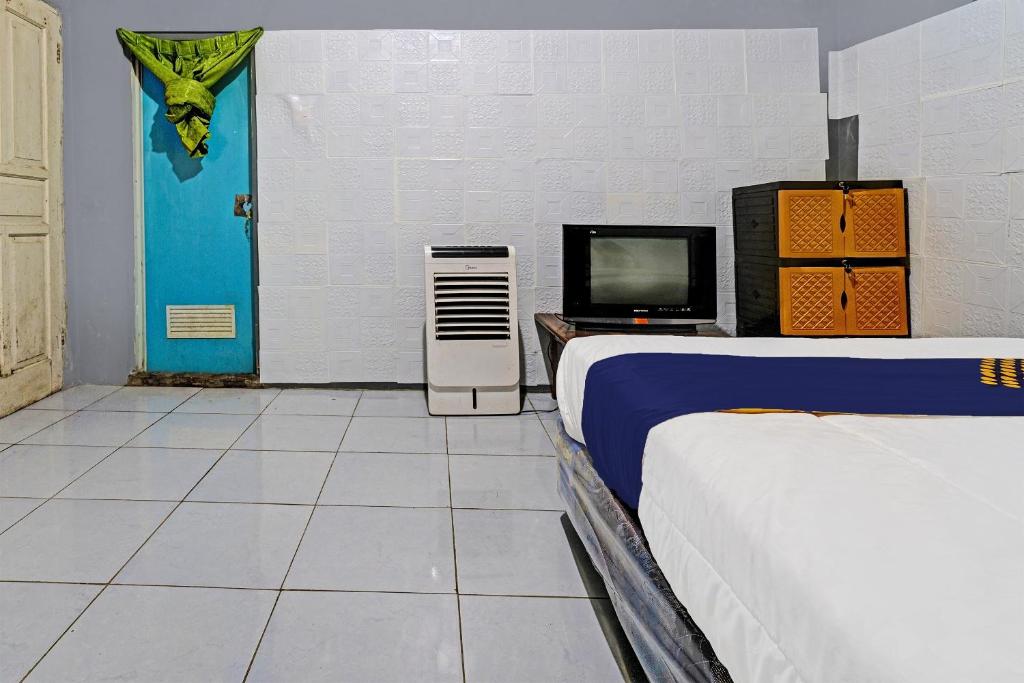 Postel nebo postele na pokoji v ubytování OYO 92269 Arjuna Homestay