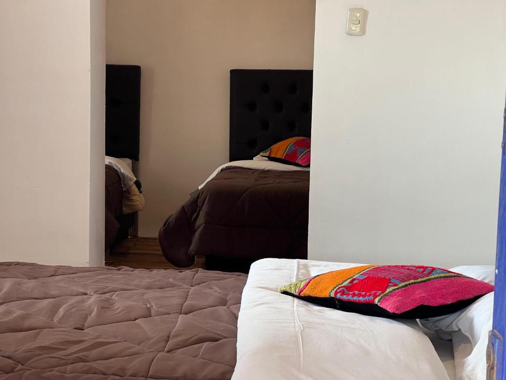Postel nebo postele na pokoji v ubytování Auquis Hostel