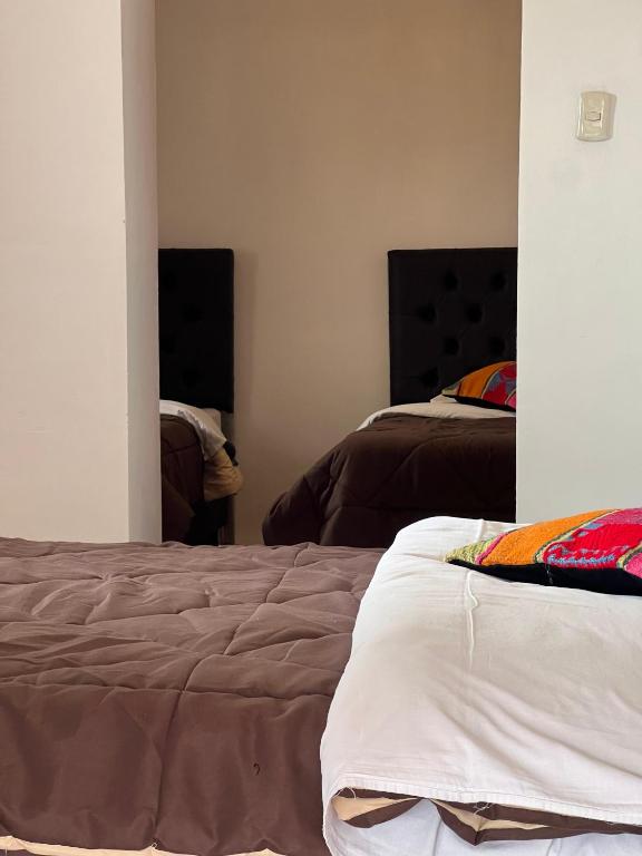 Postel nebo postele na pokoji v ubytování Auquis Hostel