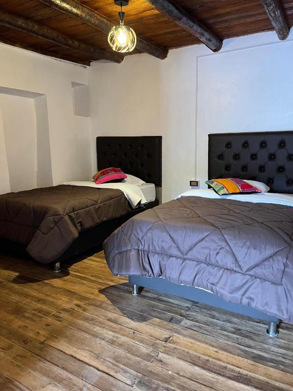Postel nebo postele na pokoji v ubytování Auquis Hostel