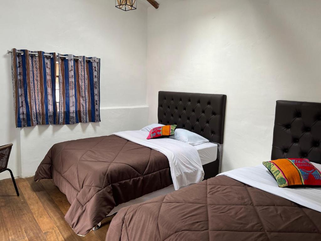 Postel nebo postele na pokoji v ubytování Auquis Hostel