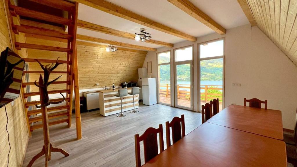 a room with a dining table and a kitchen at Cricova House in Colibiţa