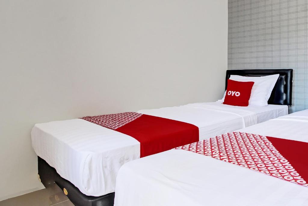 Postel nebo postele na pokoji v ubytování Super OYO Collection O 92363 Kp Inn