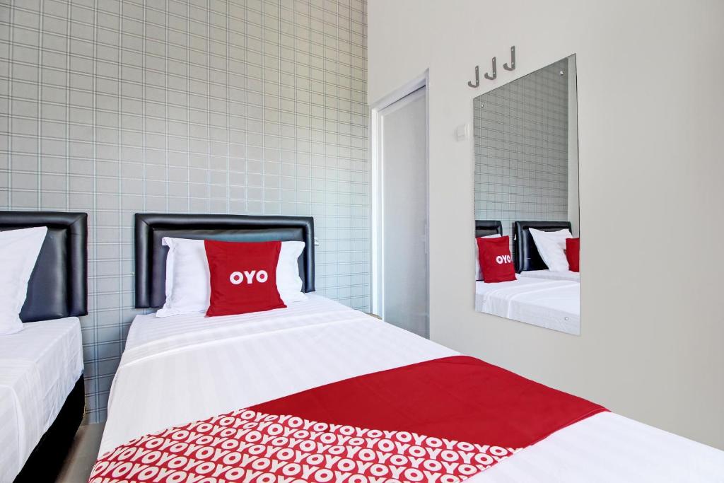 Postel nebo postele na pokoji v ubytování Super OYO Collection O 92363 Kp Inn
