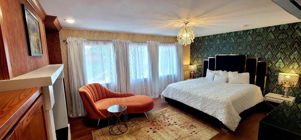 a bedroom with a bed and a chair and a window at Retro Inn at Mesa Verde in Cortez