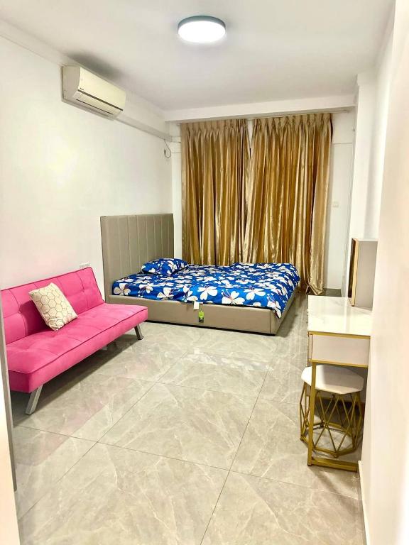 a bedroom with a bed and a pink couch at Riverside Apartment in Phnom Penh