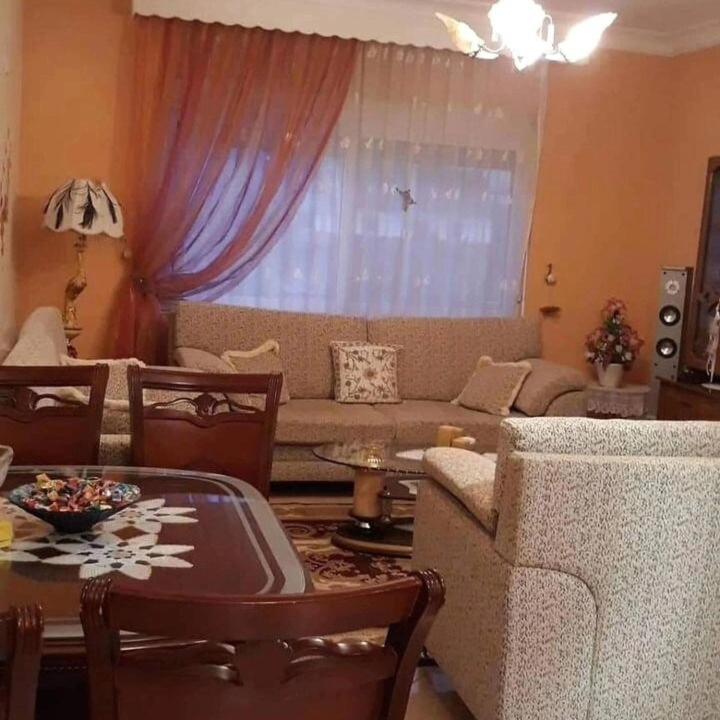 a living room with a couch and a table at Villa Topuzi Second Floor in Pogradec